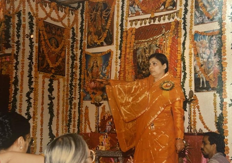 Offering aarti at a festively decorated shrine — from her earlier years