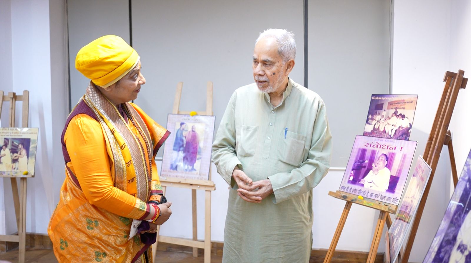 Viewing a commemorative photo exhibition with a guest