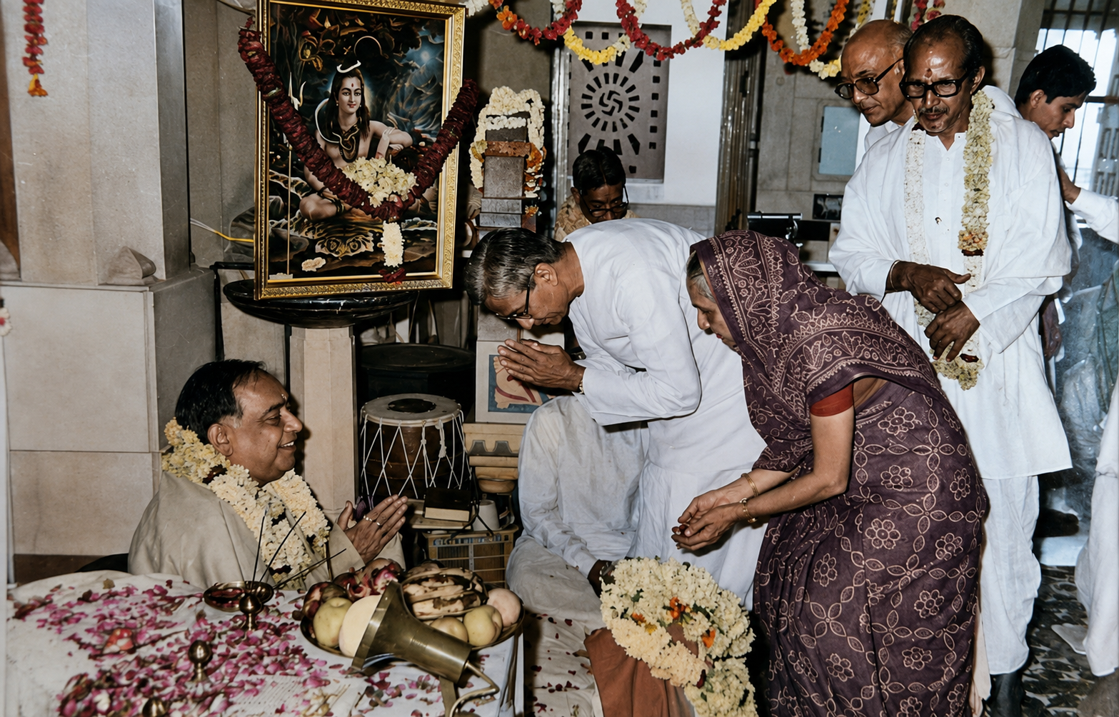 Devotees offering pranam and seeking blessings at a satsang