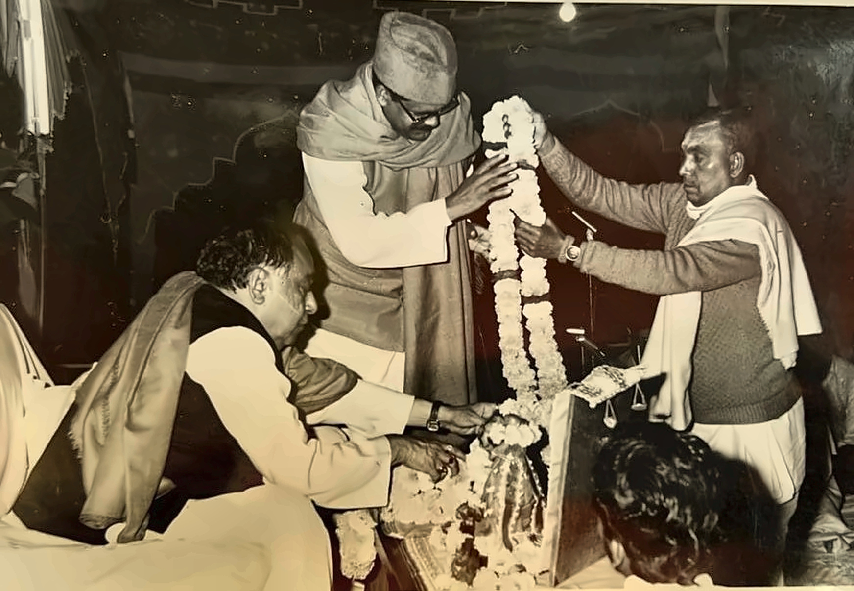 Garlanding a portrait at a commemoration ceremony